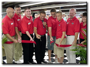 Mike Yeager helps cut the ribbon on his new plant