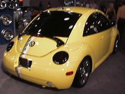 1998 vw beetle with wheels, a wing, and light covers
